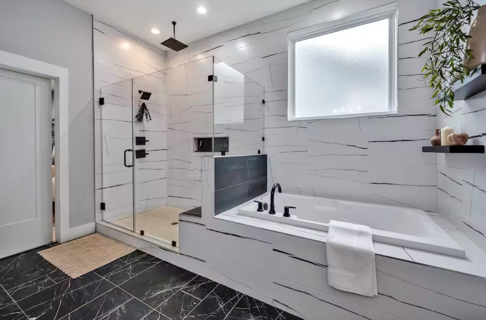 Master bathroom with frameless glass walk-in shower and built-in soaking tub